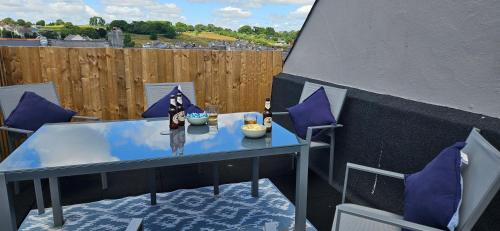 a table and chairs with a figurine on a balcony at Spacious Penthouse in Central Plymouth 3 Large Bedrooms in Plymouth