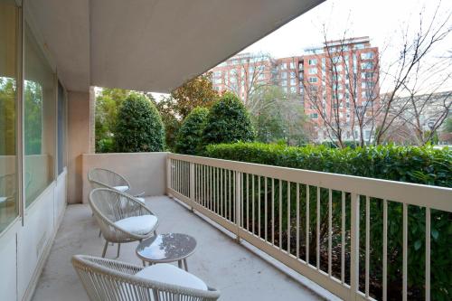 a balcony with two chairs and a table at Spacius Apt W Excellent Amenities in Arlington