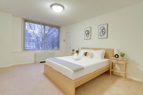 a white bedroom with a large bed and a window at Spacius Apt W Excellent Amenities in Arlington