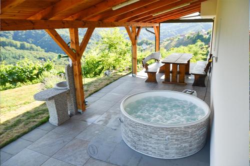 a large tub sitting on a patio with a table at Gold Wine Estate in Podlehnik