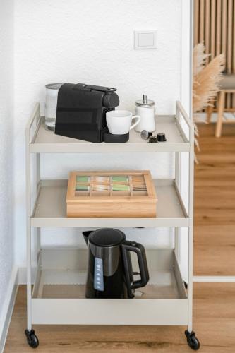 a white shelf with a coffee maker on it at Für 6 l Zentral l Parken l Universität l Balkon in Bochum