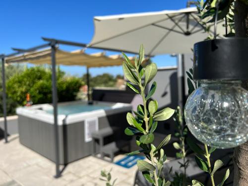 a patio with a table and an umbrella at Apartment Infinity Blue in Mlini