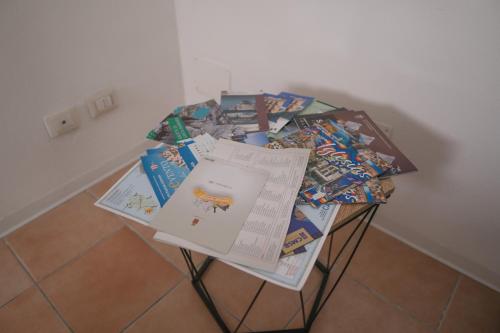 a table with a bunch of books on it at Casa Lumiere in Iglesias