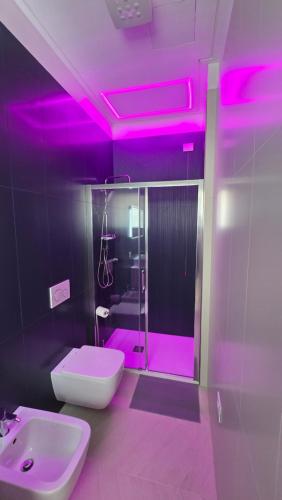a bathroom with a pink lighting on the ceiling at RESIDENZA GIULIA e LIDIA - PERLA DELL'ADRIATICO in Grottammare