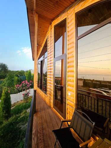a porch of a house with a chair on it at Royal Ak-Terek Issyk-kul in Ak-Terek