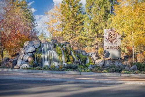 a waterfall in a park with a sign in the foreground at Wood Duck 5 in Bend