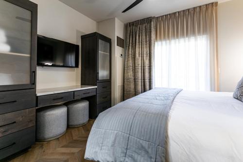 a bedroom with a large bed and a television at Condos at Canyons Resort by White Pines in Park City