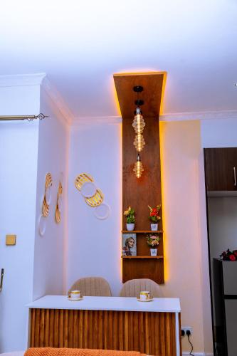 a kitchen with a counter with two chairs in a room at Icon Comfort Homes in Nalakonge