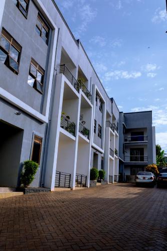 a building with cars parked in front of it at Icon Comfort Homes in Nalakonge
