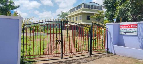 a gate in front of a building at Shinobi Lakeview Retreat in Nārāyangaon