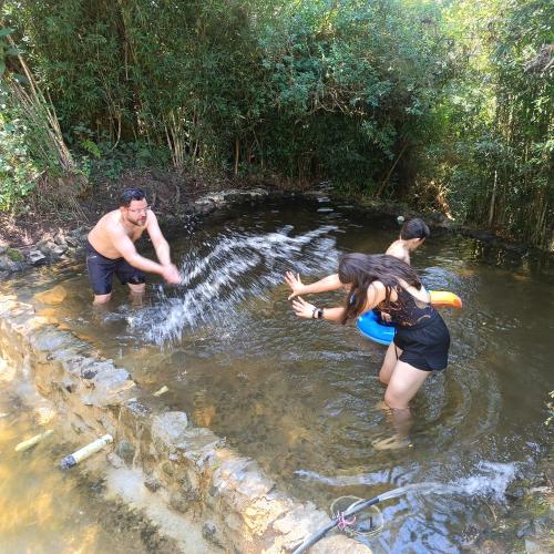 a group of people standing in the water at Cabaña Blanca Guarne cerca a Metrocable ARVI in Guarne