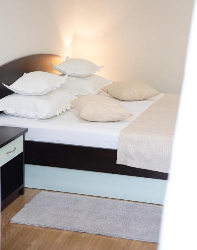 a bedroom with two beds with white sheets and pillows at Villa Alesa Steva in Tučepi