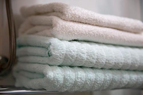 a stack of white towels sitting on a rack at Villa Alesa Steva in Tučepi