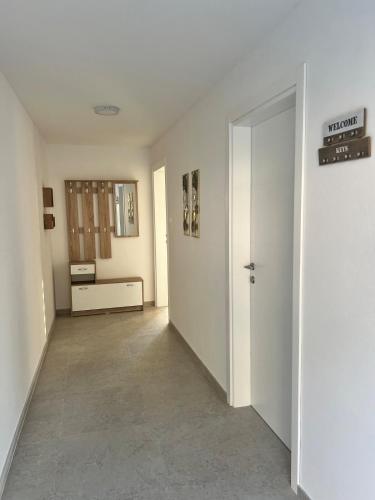 an empty room with a hallway with a door at A&A apartments in Kravlja
