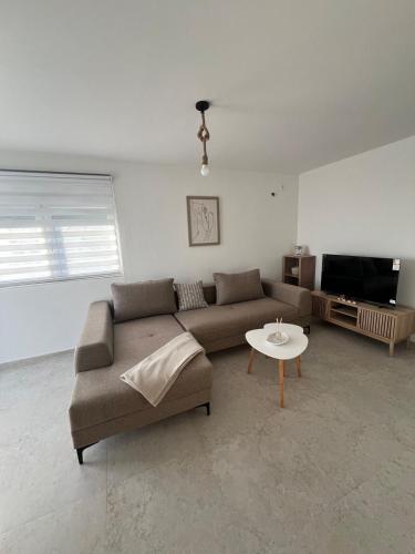 a living room with a couch and a table at A&A apartments in Kravlja