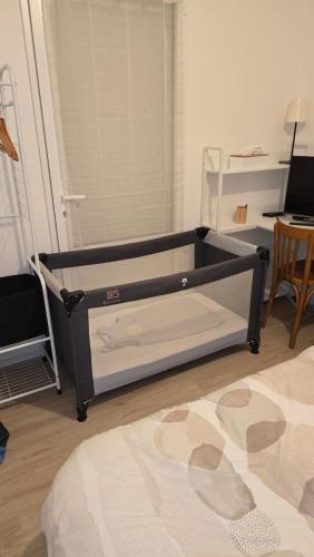 a black bed frame in a room with a table at Villa de Céline in Curzon