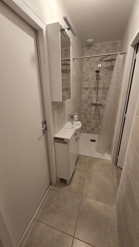 a bathroom with a toilet and a sink and a shower at Villa de Céline in Curzon