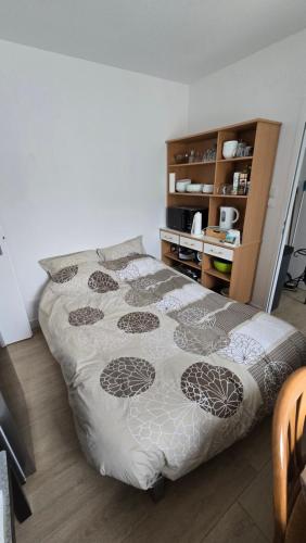 a bedroom with a bed and a book shelf at Villa de Céline in Curzon