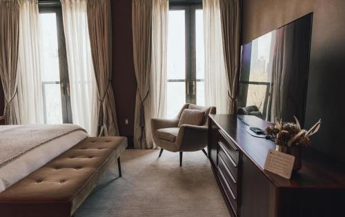 a bedroom with a bed and a desk and a chair at Fasano Fifth Avenue I Private Members Club & Hotel in New York