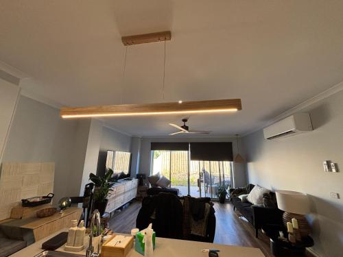 a living room with a couch and a table at JettyWalk, Stunning 3br townhouse, walk to beach in Rosebud