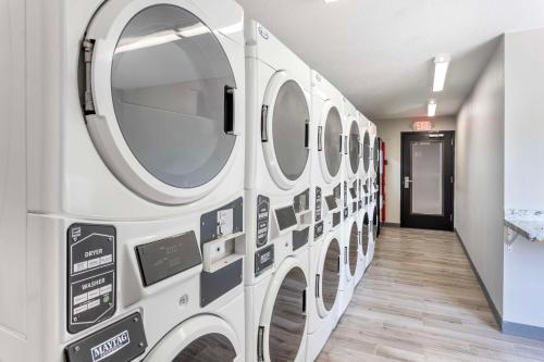 a row of washing machines in a laundry room at Executive Residency by Best Western Philadelphia-Willow Grove in Horsham