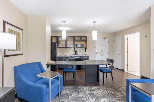a living room with a table and chairs and a kitchen at Executive Residency by Best Western Philadelphia-Willow Grove in Horsham