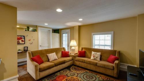 a living room with two couches and red pillows at Backyard Pool! Refresh at Rivermist Condo in Savannah