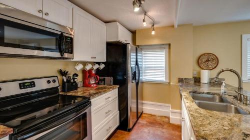 a kitchen with a stainless steel refrigerator and a sink at Backyard Pool! Refresh at Rivermist Condo in Savannah