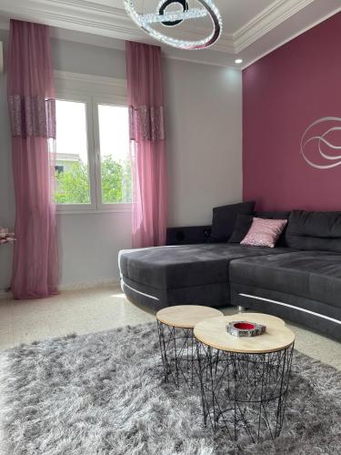 a living room with a couch and a table at Dar Misk Elil in Bizerte