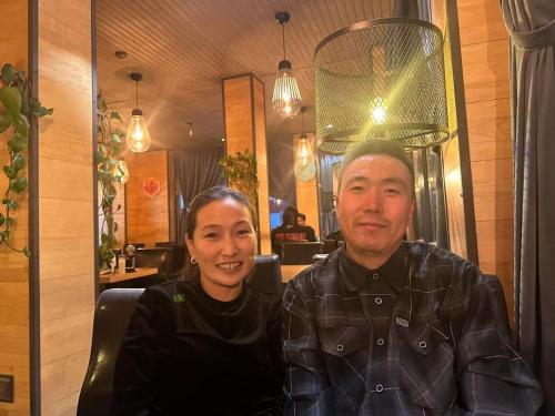 a man and a woman sitting in a restaurant at Tsahar geust house in Ulaanbaatar