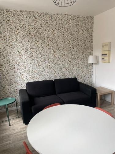 a living room with a couch and a table at Les Halles d'Isa et Thomas in Narbonne