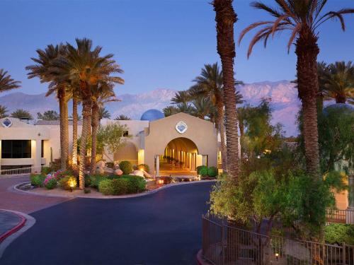 a house with palm trees and a driveway at The Westin Mission Hills 1BR Apartment with Resort Access in Rancho Mirage