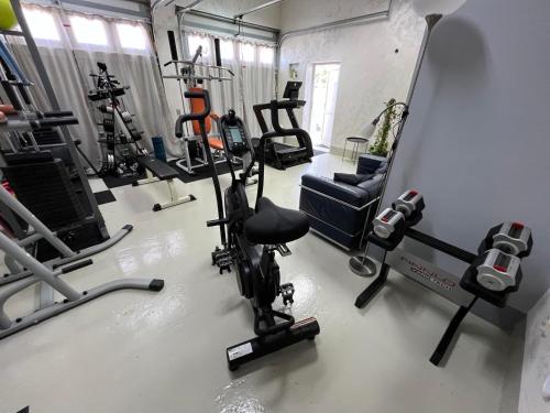 a gym with several treadying machines and a mirror at Apartment Infinity Blue in Mlini