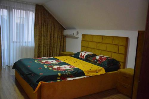 a bedroom with a large bed in a room at Vila de vacanta Curtea de Arges in Curtea de Argeş