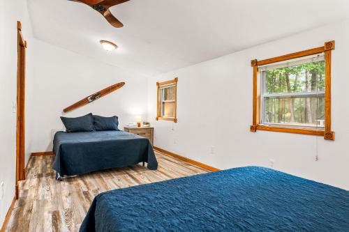 a bedroom with two beds and a window at Spacious 3 Bedroom on Arbutus Lake in Traverse City