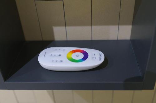 a remote control sitting on top of a shelf at Essenza in Campomarino
