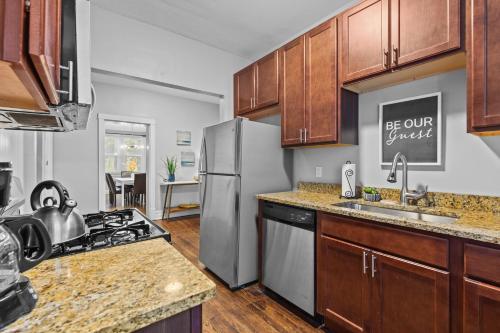 a kitchen with a stainless steel refrigerator and a stove at Botanical Bliss | JZ Vacation Rentals in Tower Grove
