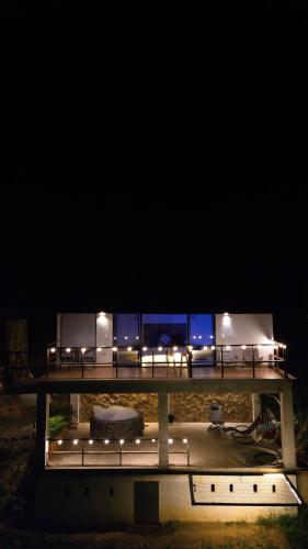a bridge with lights on it at night at Glamping Pedro in San Gil