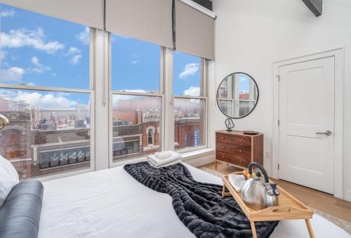 a bedroom with a large bed with a large window at The Saddlery-Playlist-2 Units-Walk to Broadway in Nashville