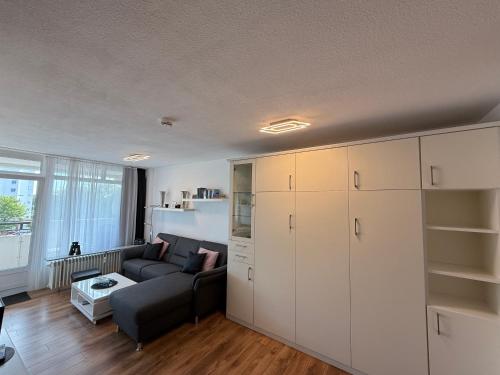 a living room with white cabinets and a couch at Panorama Whg 42, 2 OG in Cuxhaven