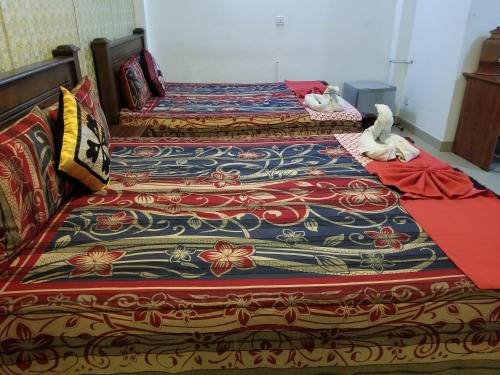 a group of three beds sitting next to each other at New Kings Gate Airport Transit Hotel in Katunayake
