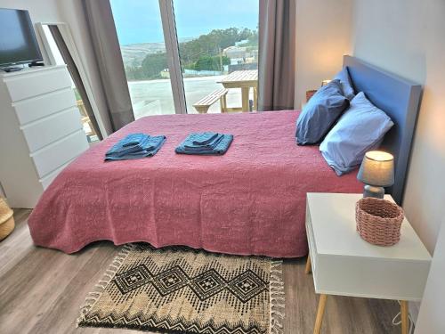 a bedroom with a bed with a large window at Ericeira Ribamar Sea View Villa in Santo Isidoro