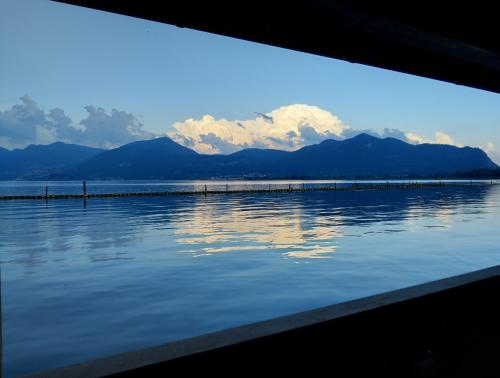a view of a body of water with mountains in the background at FilandaLago Apartment in Iseo