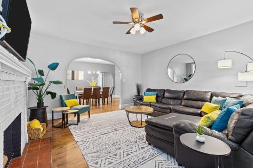 a living room with a couch and a dining room at Botanical Bliss | JZ Vacation Rentals in Tower Grove