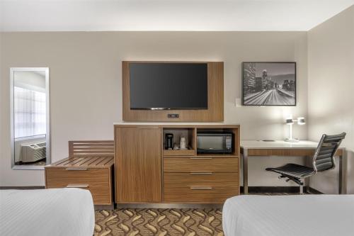 a hotel room with a flat screen tv on the wall at Best Western Airport Plaza Inn Hotel - Los Angeles LAX in Los Angeles