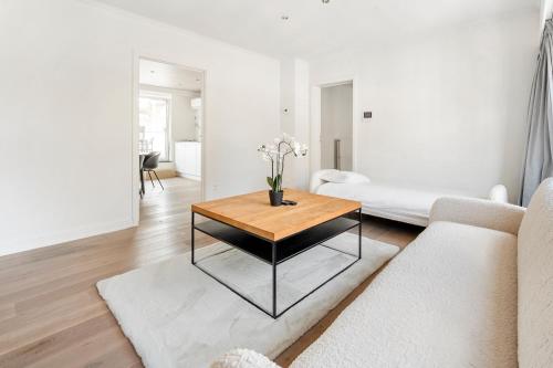 a living room with a table and a couch at Luxury apartment x big terrace in Sint-Niklaas