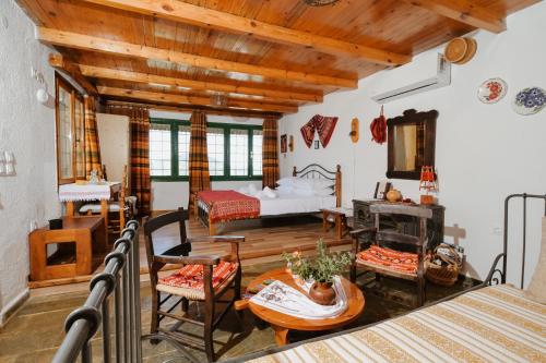 a room with a bed and a table and chairs at Villa Kamari- Stunning Views in Kritsá
