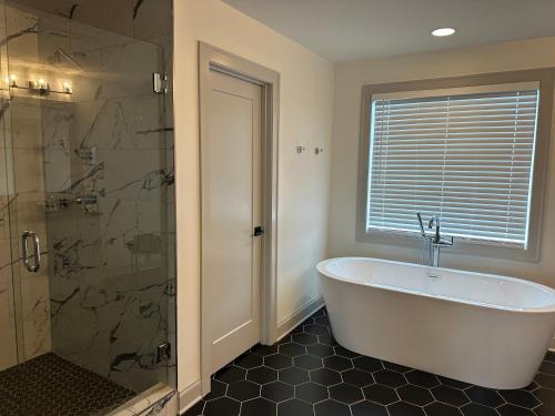 a bathroom with a bath tub and a shower at 4-bedroom Lake house in Twin Creeks Winchester TN with Lakeview's, hot tub, pool in Winchester