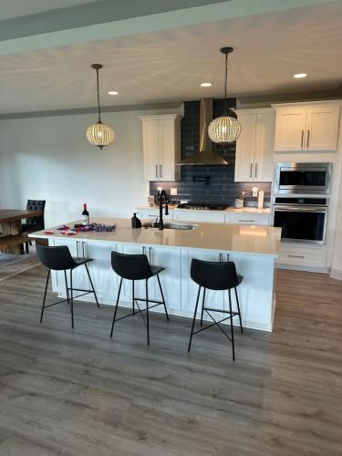a kitchen with a large island with chairs around it at Tim Ford Lake House in Twin Creeks TN in Winchester