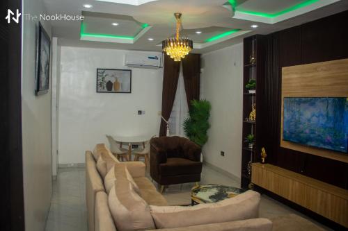 a living room with a couch and a table at The NookHouse in Calabar